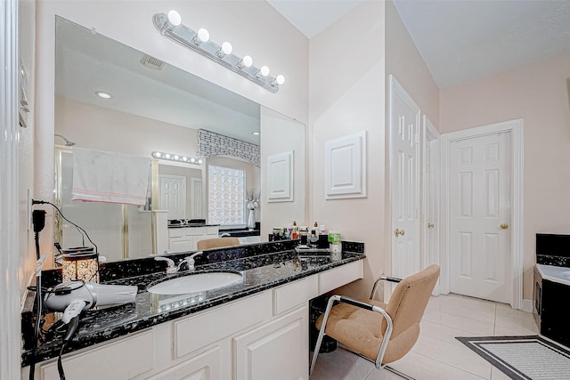 bathroom with a stall shower, tile patterned flooring, visible vents, and vanity