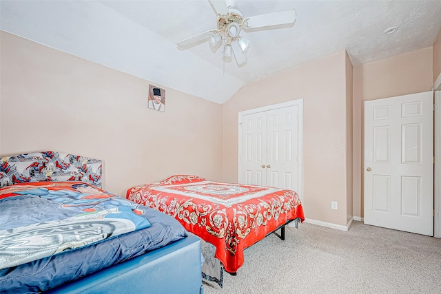 bedroom with baseboards, a ceiling fan, lofted ceiling, carpet, and a closet