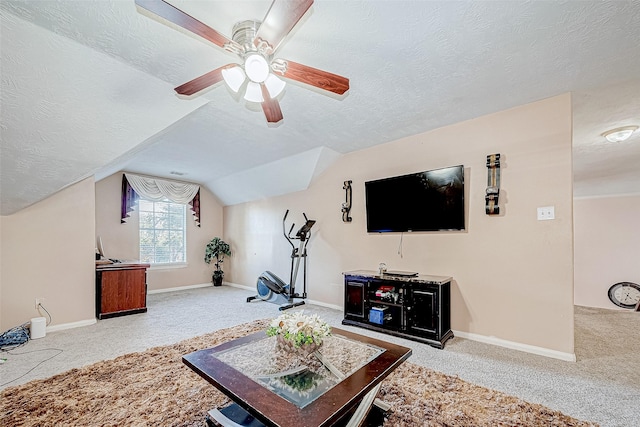 carpeted living area featuring ceiling fan, baseboards, vaulted ceiling, and a textured ceiling