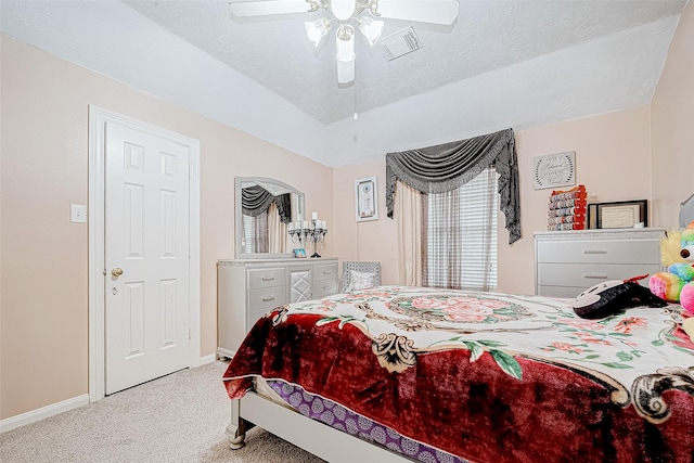 carpeted bedroom with visible vents, ceiling fan, a textured ceiling, and baseboards