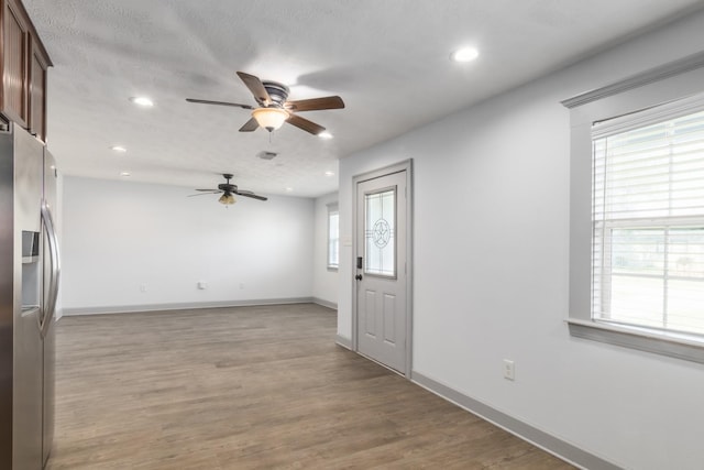 interior space featuring recessed lighting, baseboards, visible vents, and light wood finished floors