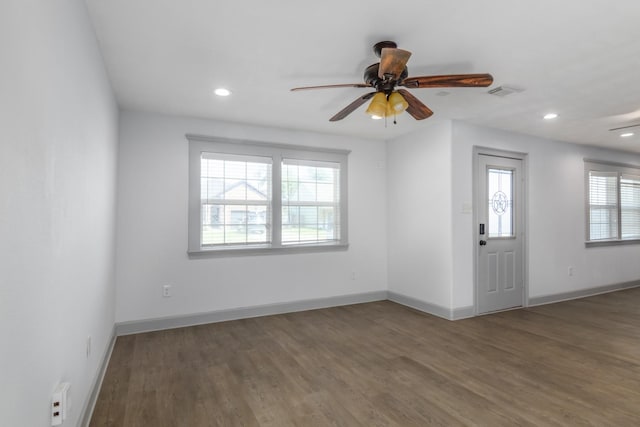 spare room with a ceiling fan, recessed lighting, baseboards, and wood finished floors