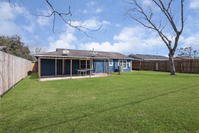 back of property featuring a patio, a lawn, and a fenced backyard