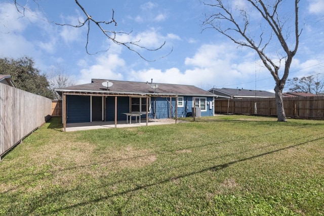 back of house with a patio area, a fenced backyard, and a lawn