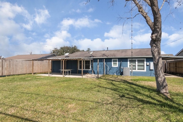 rear view of house featuring a patio, a lawn, fence private yard, and central air condition unit