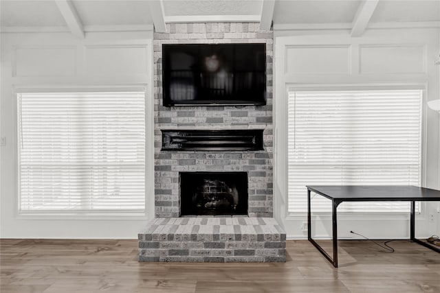 3610 Cypresswood Dr, Spring, TX 77388 - living room featuring beam ceiling, a fireplace, and wood finished floors