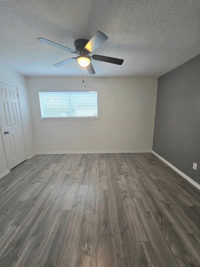 3610 Cypresswood Dr, Spring, TX 77388 - unfurnished room with dark wood-type flooring, ceiling fan, a textured ceiling, and baseboards