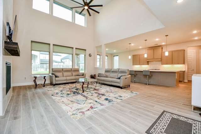 living area with wood tiled floor, baseboards, and recessed lighting