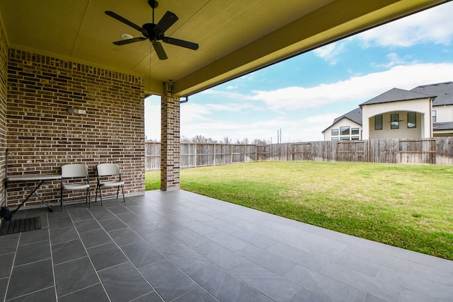 view of patio featuring ceiling fan and fence