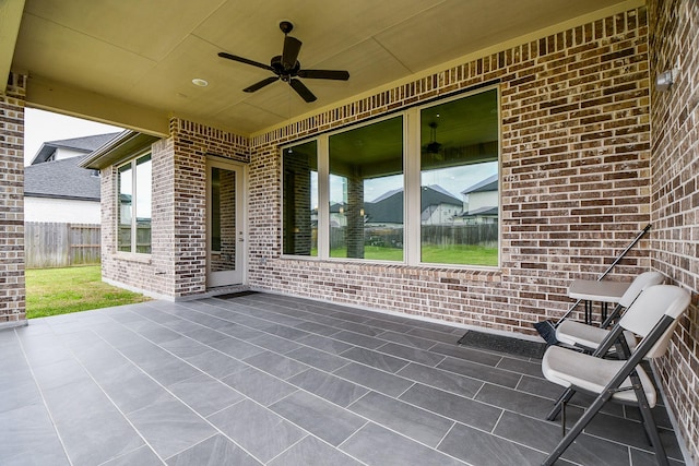 view of patio featuring ceiling fan and fence