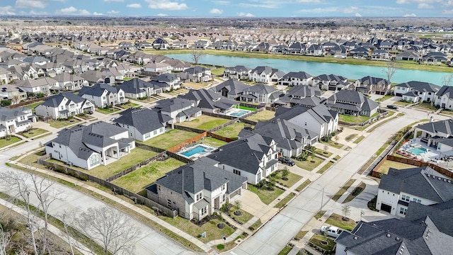 bird's eye view featuring a residential view and a water view