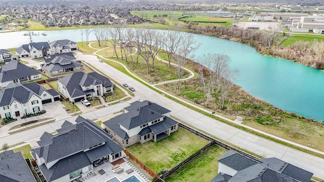 bird's eye view featuring a water view and a residential view