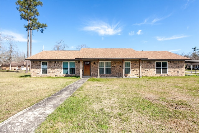 ranch-style home with brick siding, a shingled roof, and a front yard