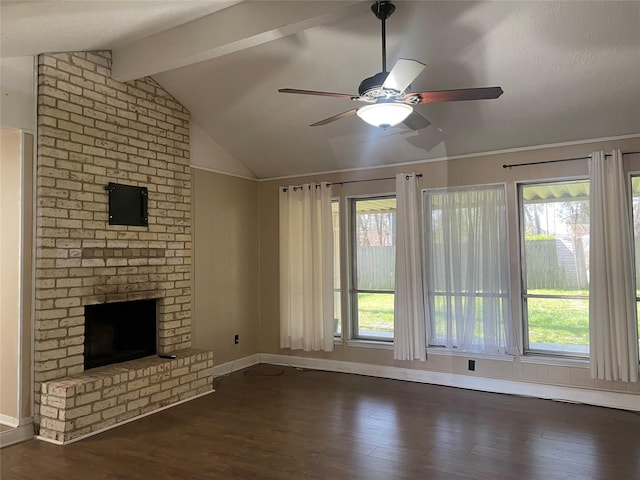 unfurnished living room with vaulted ceiling with beams, ceiling fan, wood finished floors, baseboards, and a brick fireplace