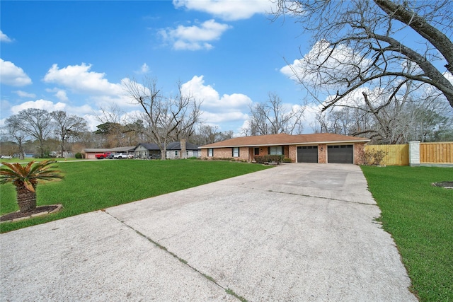 ranch-style home with brick siding, fence, concrete driveway, a front yard, and an attached garage