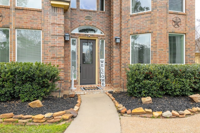 property entrance with brick siding