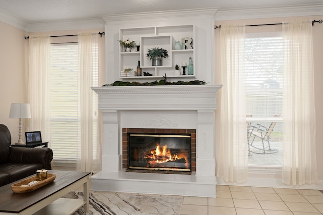 interior space featuring ornamental molding and a glass covered fireplace