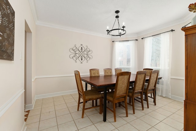 dining area featuring crown molding, baseboards, a notable chandelier, and light tile patterned flooring