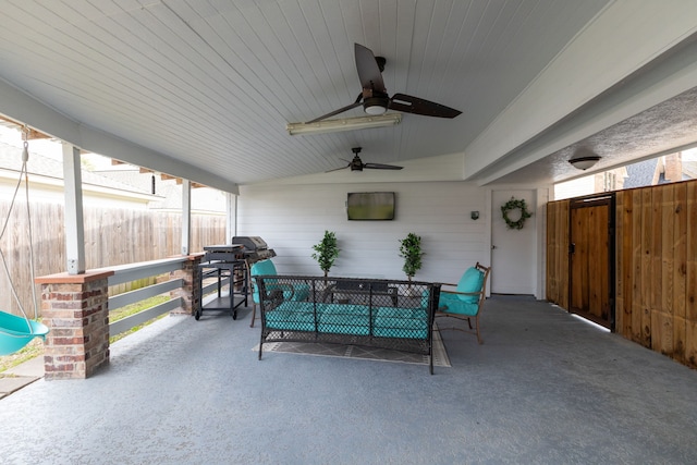 view of patio with ceiling fan and fence