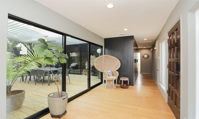 corridor with visible vents, wood finished floors, and recessed lighting