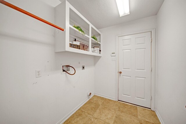 washroom with baseboards, laundry area, hookup for a washing machine, electric dryer hookup, and a textured ceiling