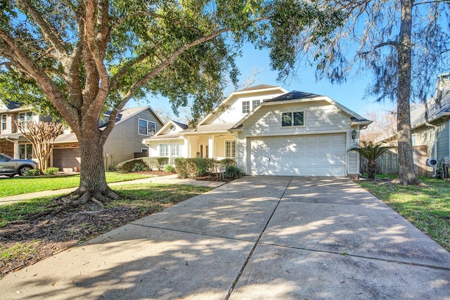 view of front facade featuring an attached garage, concrete driveway, and fence