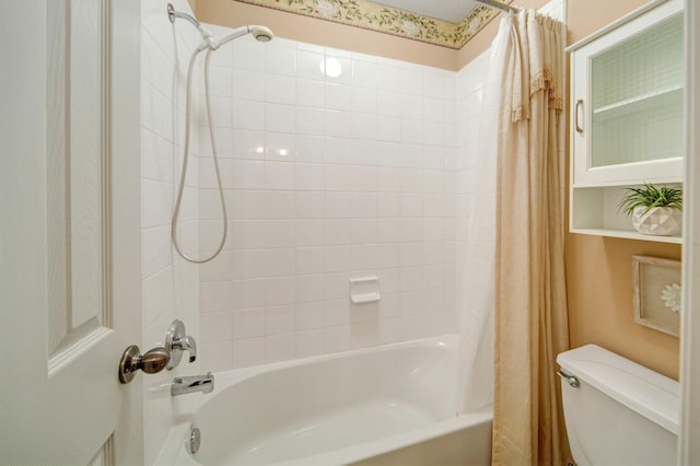 bathroom with shower / tub combo with curtain and toilet