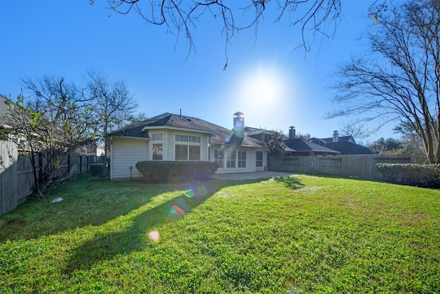 back of house featuring a patio area, a lawn, and a fenced backyard