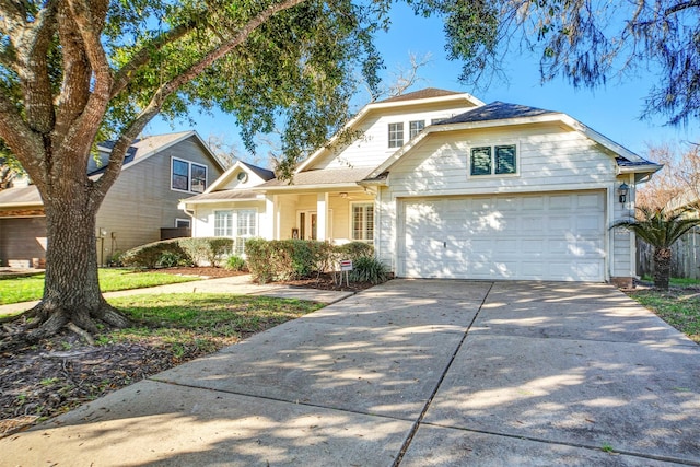 view of front of home with concrete driveway and an attached garage