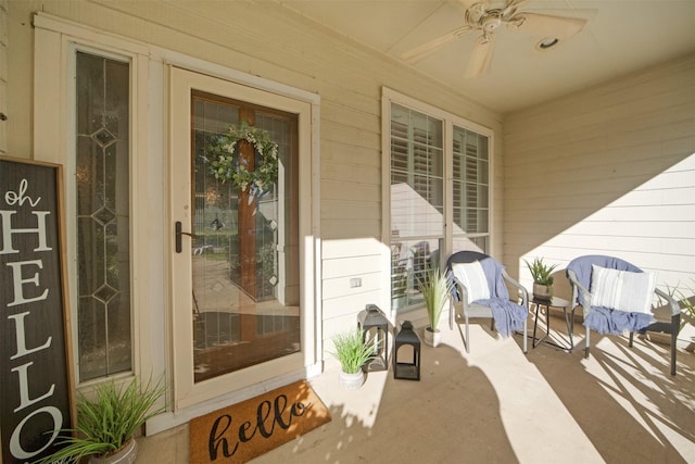 property entrance featuring a porch and ceiling fan