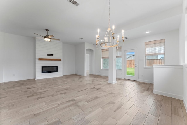 unfurnished living room with visible vents, light wood-style floors, a large fireplace, ceiling fan, and baseboards