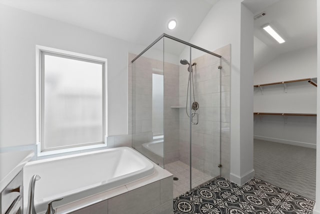 full bath with a stall shower, visible vents, a spacious closet, vaulted ceiling, and a bath