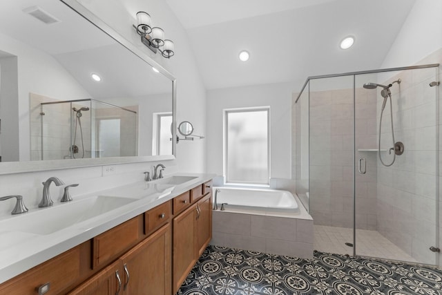 full bath featuring a stall shower, visible vents, tile patterned floors, vaulted ceiling, and a sink