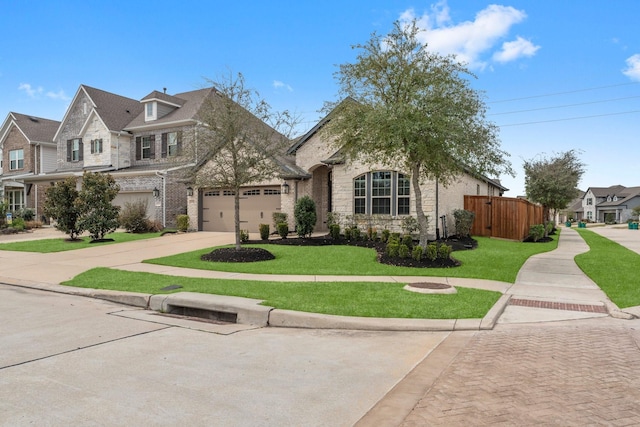 view of front facade with a front yard, concrete driveway, brick siding, and fence