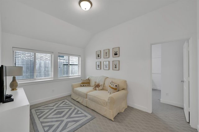 living room with lofted ceiling, carpet flooring, and baseboards