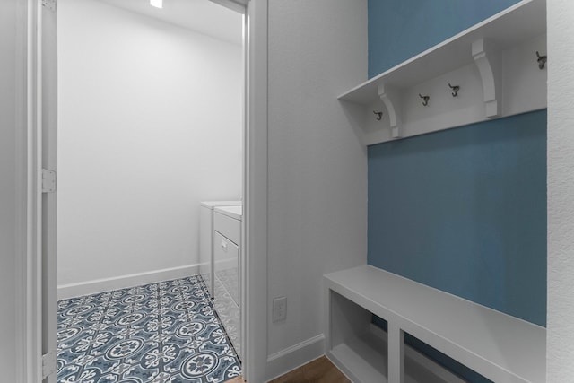 mudroom with independent washer and dryer, baseboards, and tile patterned floors