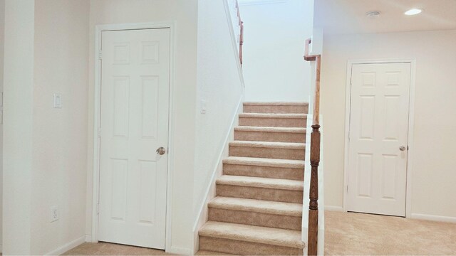 staircase with carpet, baseboards, and recessed lighting