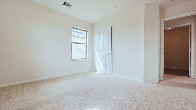 unfurnished bedroom featuring carpet flooring, visible vents, and baseboards