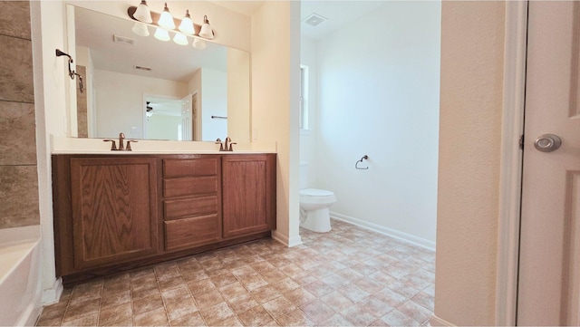 full bathroom with toilet, double vanity, visible vents, and baseboards