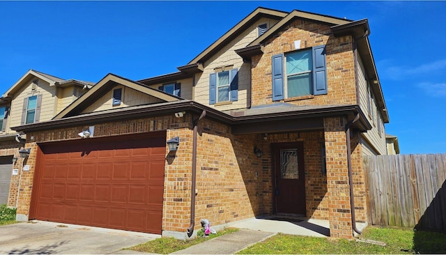 view of front of home with concrete driveway, brick siding, and fence