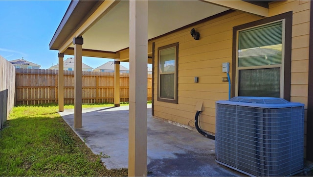 view of patio / terrace featuring fence and central air condition unit