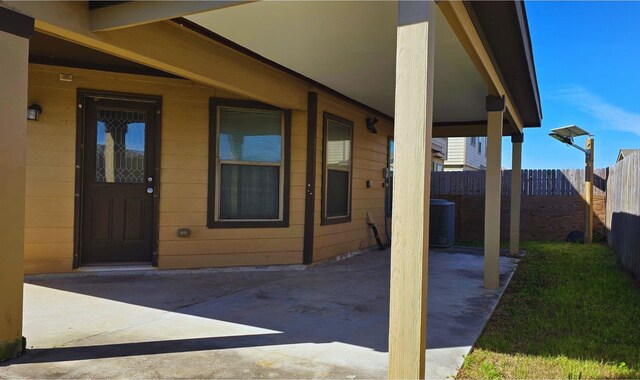 view of patio featuring central AC unit and fence