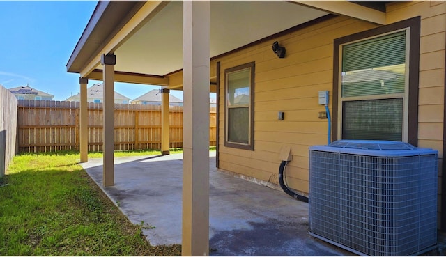 view of patio featuring central AC and fence