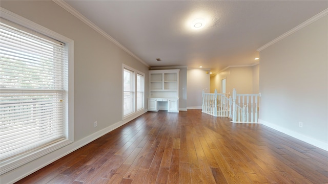 unfurnished living room featuring ornamental molding, dark wood-style flooring, and baseboards