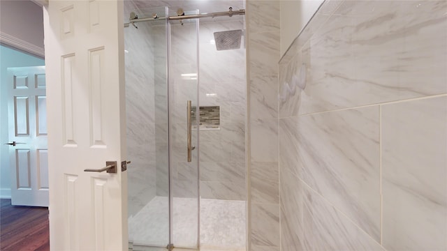 bathroom with a stall shower and wood finished floors