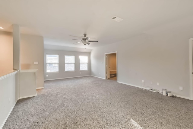 unfurnished room featuring ceiling fan, carpet, visible vents, and baseboards