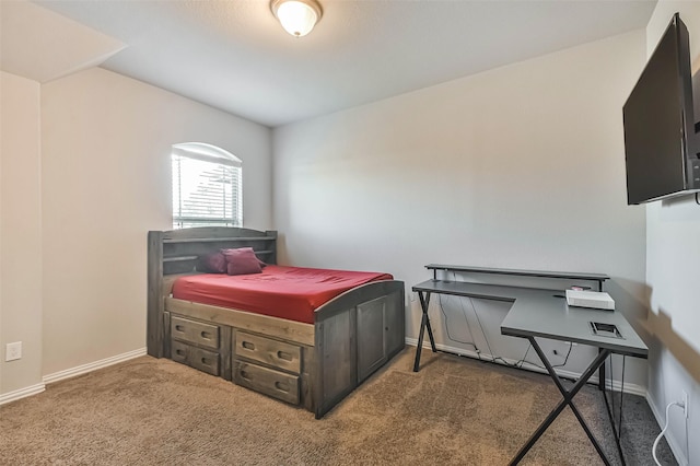 carpeted bedroom featuring baseboards