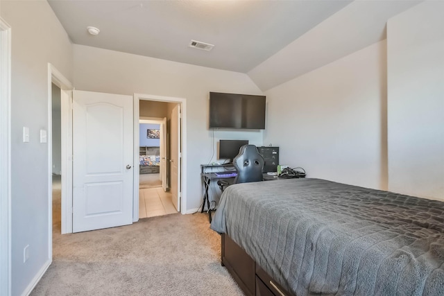 bedroom featuring light colored carpet, visible vents, and lofted ceiling