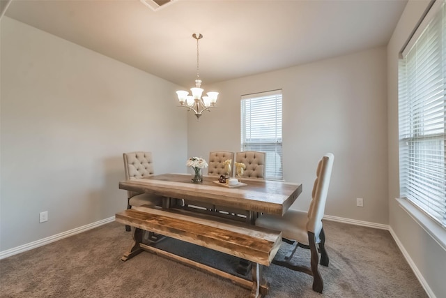 dining space with carpet floors, a chandelier, visible vents, and baseboards