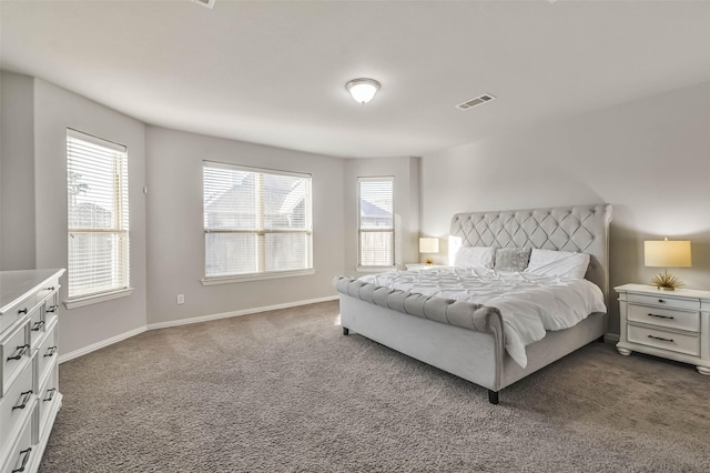 bedroom featuring visible vents, dark carpet, baseboards, and multiple windows